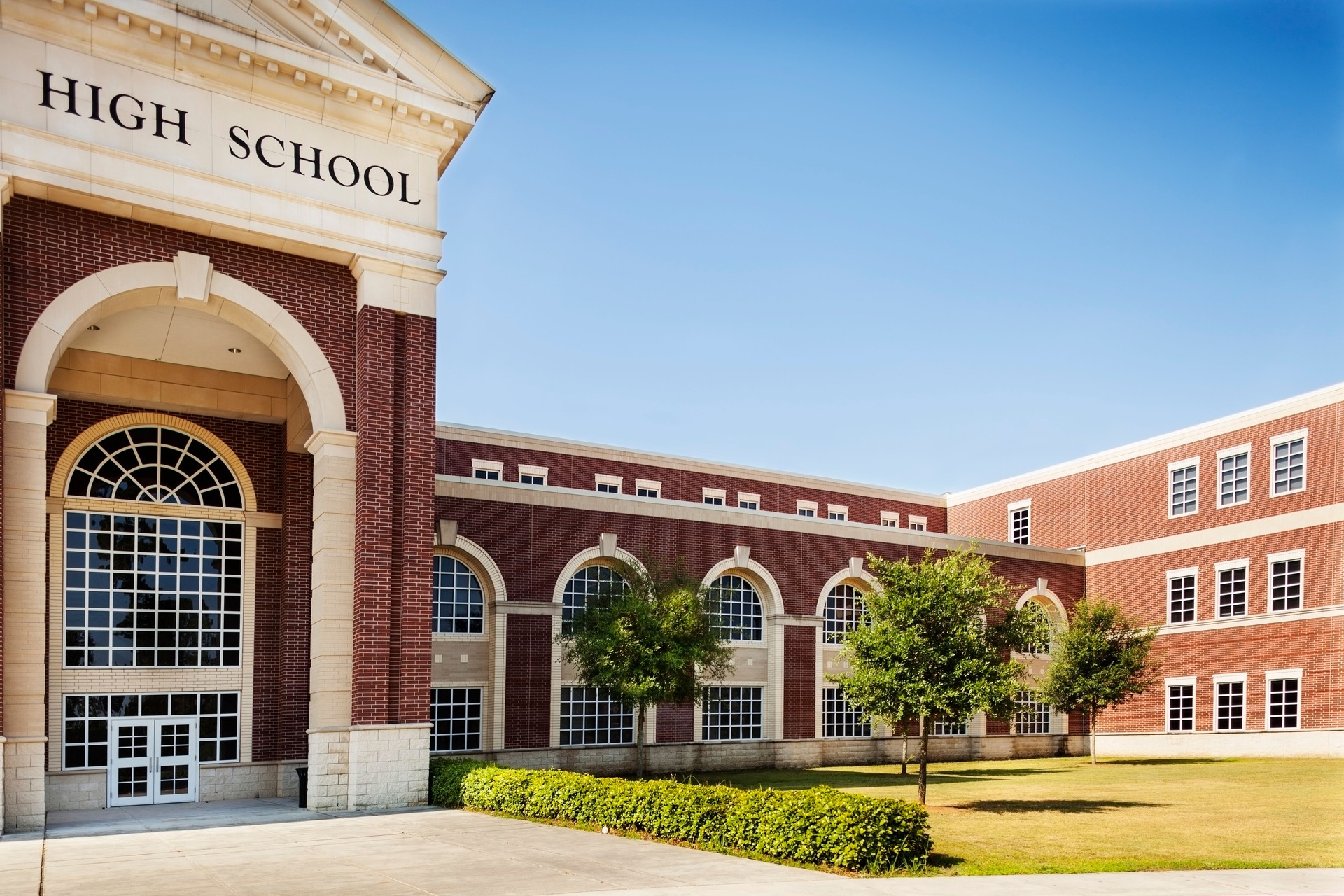 Education:  High school building entrance.  Copyspace and sky.